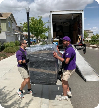 Double Move movers carefully lifting and loading a large box into a moving truck during professional moving service