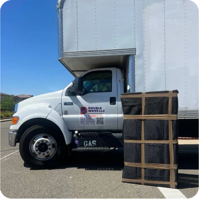 Double Move moving truck with packed items placed nearby ready for loading and transport