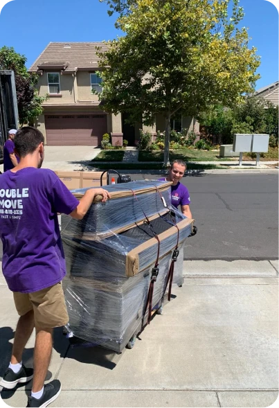 Double Move movers carefully loading a piano into a moving truck during professional moving service in Sacramento