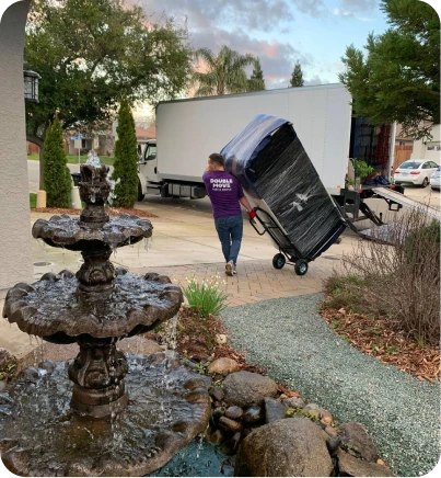 Double Move mover carrying customer belongings on a dolly and loading them into a truck during moving service in Sacramento