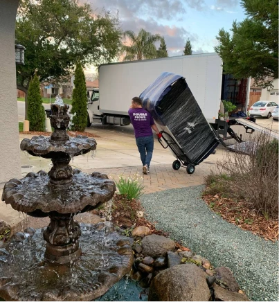 Double Move mover carrying packaged goods and loading them into a truck during professional moving services in Sacramento