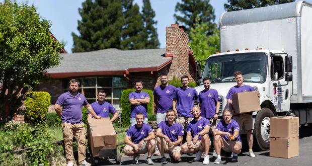 Double Move moving team standing by a truck with packed boxes during a professional photoshoot in Sacramento