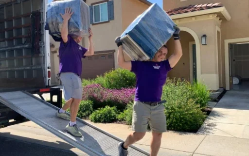 Double Move movers loading packaged goods from a truck during professional moving services in Sacramento