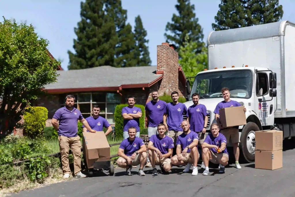 Double Move long distance moving crew with boxes in front of their truck
